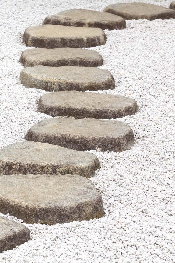 stone pavers forming a winding path on small rock bed